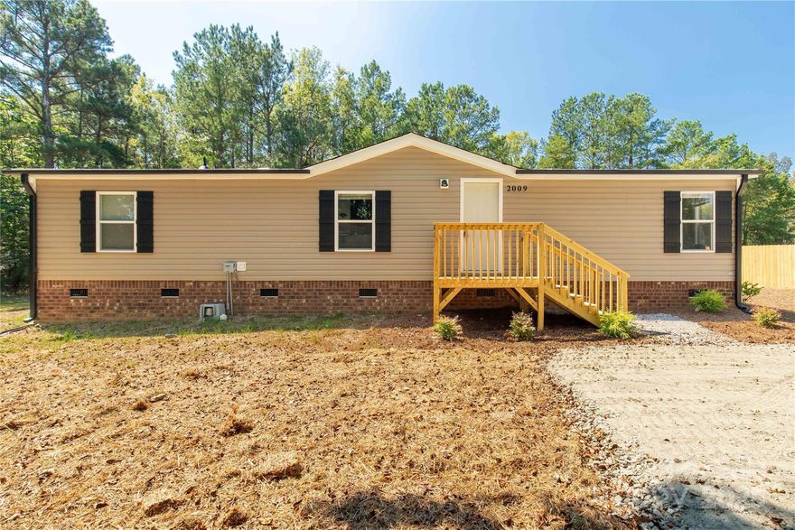 Welcome to 2009 Sugar Hill, a fully remodeled three-bedroom, two-full-bath home ready for you to make it your own. This home features a split floor plan, with the primary bedroom offering a walk-in closet and an en-suite bathroom. The main living areas boast beautiful and durable LVP flooring, while the bedrooms are carpeted. The kitchen is impressive with its white cabinetry, granite countertops, stainless steel appliances, and ample space. The living room is highlighted by a charming brick fireplace. Both the primary and secondary bathrooms feature granite tops as well. The home is located on a spacious one-acre lot, set back from the road for enhanced privacy.