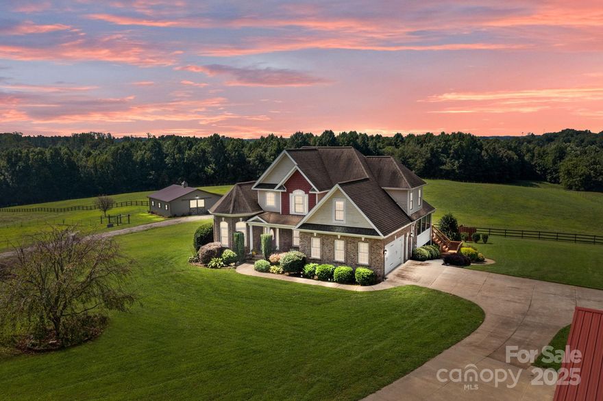Discover the perfect blend of comfort, privacy, and functionality on this 46.84-acre North Iredell estate  - affectionately named “Ridgetop”. Tucked away from the road, this 5-bedroom, 4-bath home offers scenic views, wooded trails, abundant wildlife, and a creek running through the property.

Ideally suited as a private equestrian estate, hobby farm, or boarding/training center, the property features a 4-stall center-aisle barn built in 2020 by Ever Trust Construction LLC with matted stalls, insulated tack room with A/C, hay storage, outside wash station, fans, and two frost-free pumps. The property includes a 7+/-  acre pasture with a combination of 4-strand electric + post and rail fencing, plus an additional 1.5–2 acre pasture with 3-strand electric fencing. A service road provides easy access to the barn.

The main home showcases hardwood floors, ceramic tile, crown molding, chair rail detailing, recessed lighting, and expansive windows that frame the pasture views and panoramic countryside. Primary bedroom has tray ceiling, beautiful bath and huge walk in closet. 3 bedrooms upstairs with Jack & Jill bath. A second living quarters in the basement includes a full kitchen, ideal for multigenerational living, guests, or rental opportunities.

Outdoor living is a highlight with a spacious deck, screened porch, and a covered walk-out patio for entertaining or relaxing and a heated 16' x 38' Figerglass Ionizer Pool with travertine pool surround, 6' 3" at deep end with sunshelf (new pump 2024).


Outbuildings include a 1200 sq ft workshop with water, electric, and wood stove plus a 24' x 24' open shed for storing equipment.

This property combines the best of country living with modern convenience—ready to support equestrian pursuits, farming, or simply enjoying a private retreat surrounded by nature. Located in Northern Iredell and convenient to major interstates 77 and 40.