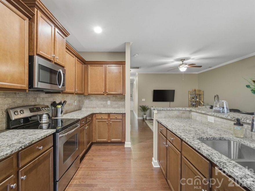 Immaculate,  beautifully maintained 3-bedroom, 2.5-bath home located in the desirable Village of Prestwick. This inviting residence offers a thoughtful blend of style, comfort, and functionality, perfect for modern living. Step inside to find hardwood floors that flow through the main living areas, creating a warm and cohesive feel. The open-concept layout makes entertaining effortless, with abundant natural light enhancing the spacious living and dining areas. The kitchen is a standout feature, showcasing granite countertops, stainless steel appliances, and ample cabinetry—ideal for both everyday meals and hosting guests. The kitchen seamlessly connects to the main living space, making it the heart of the home. Upstairs, the primary suite provides a private retreat with an en-suite bath, while two additional bedrooms offer flexibility for guests, a home office, or a growing household. With 2.5 bathrooms, the home is well-suited for both convenience and privacy. Community features include 2 outdoor pools, dog park, clubhouse.  Located just minutes from shopping, dining, and major commuting routes, 4648 Craigmoss Lane combines comfortable living with everyday convenience in a sought-after area of Charlotte. Washer, dryer, refrigerator all convey, some furnishings can be purchased, making this home completely move in ready!