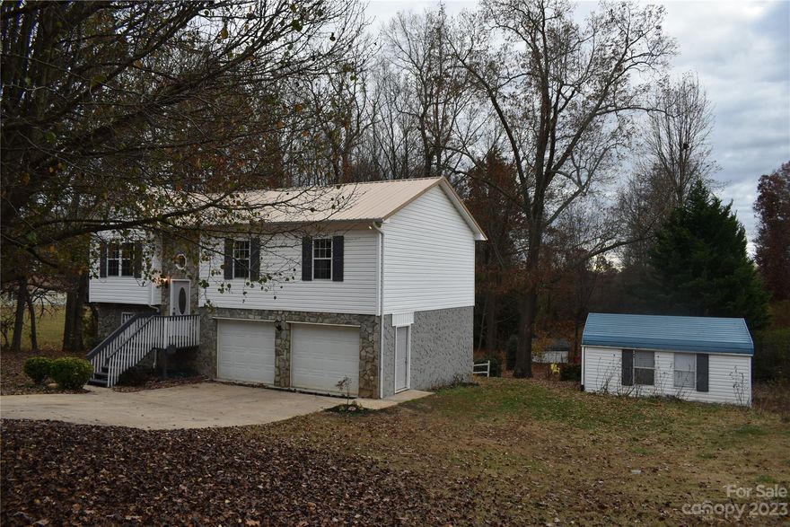 Just finished a complete remodel both inside and out, including landscaping.  Refinished hardwoods on the main level, new step treads, new LVP flooring in baths and basement. New paint throughout interior and exterior, new lighting & ceiling fans throughout, new granite countertops in kitchen and both baths. New commodes, faucets and shower heads, new range/refrigerator/microwave, Bosch dishwasher. New EHP/CAC, new garage door openers. New side door. New finished basement includes a den and large laundry room. Covered rear deck overlooks cleared and partially wooded very private back yard with large trees and decorative split rail fence. The second storage building also has a shed. Additional workshop has concrete floor, flue and electrical for any use needed. Nothing left to do with this one but move in and put up your Christmas Tree.