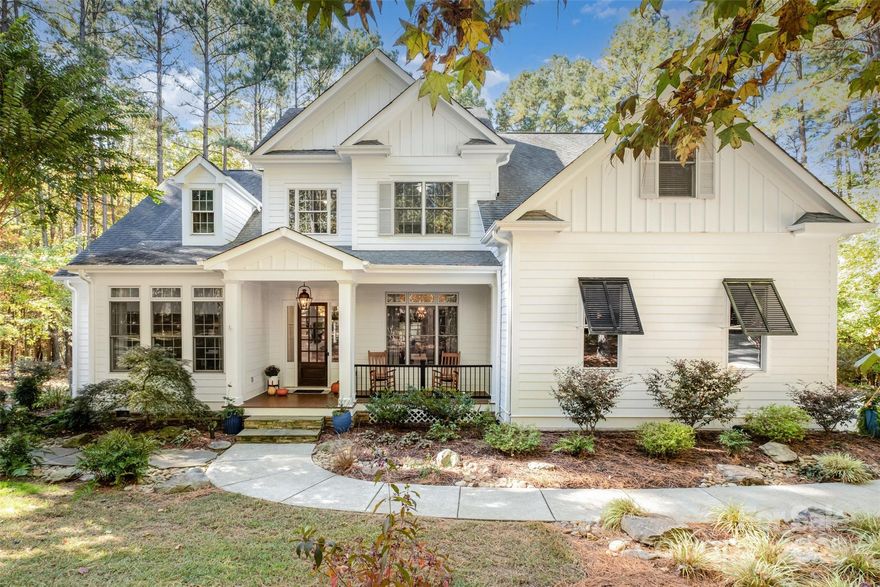 This modern luxury estate in The Farms offers true resort living on 2.1 private acres. Bordered by protected water-company land and the community greenway, it’s one of the most private homes in the neighborhood. The 4BR/3.5BA main home features soaring ceilings, hardwoods throughout (no carpet), designer lighting, neutral paint, and a new built-in bar. The chef’s kitchen includes a 48" gas range with double ovens, drawer microwave, and custom cabinet pantry. A double-sided fireplace opens to a screened deck overlooking the 40’ heated saltwater pool with 7’ depth, swim-up bar, and 8+ person spa. Outdoor features include stone walkways, bonfire pit. 

One of the few properties in The Farms with a carriage house, the detached carriage house offers a studio-style space with kitchenette, ¾ bath, washer/dryer hookups, and dual-zone mini-split that also temp-controls the garage. Main home has two HVAC units and two hot water tanks, plus a third serving the carriage house. Both garages feature lift-ready ceilings. 

The Farms amenities include clubhouse, pool, tennis, pickleball, soccer fields, holiday events, and boat/RV storage available. Lake Norman access just minutes away.