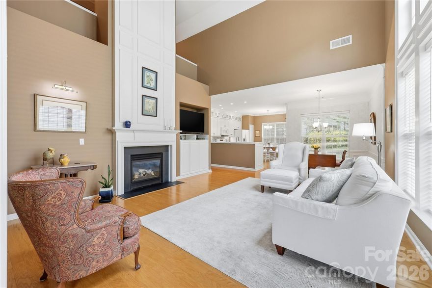 If you’ve been searching for a home with character, natural light, and low-maintenance living, this one stands out from the moment you walk in. This charming 3-bedroom, 3-bath home in Highland Creek features a soaring two-story great room with a dramatic wall of windows, custom fireplace molding, and an airy open feel throughout- creating a space that feels both elegant and inviting.

The main floor primary bedroom and renovated ensuite provide the perfect space for relaxing.

The renovated bright, white kitchen shines with illuminated glass display cabinetry, modern finishes, and an easy flow for everyday living and entertaining.

Upstairs, a private second-floor retreat with its own full bath offers incredible flexibility — perfect for guests, a quiet home office, bonus room, or creative space.

Even better? Lawn maintenance is included through the HOA quarterly fees, giving you more time to enjoy the exceptional neighborhood amenities including golf, multiple pools, tennis and pickleball courts, bocce ball, clubhouse access, and a large open park directly across the street. This home really does check all the boxes.