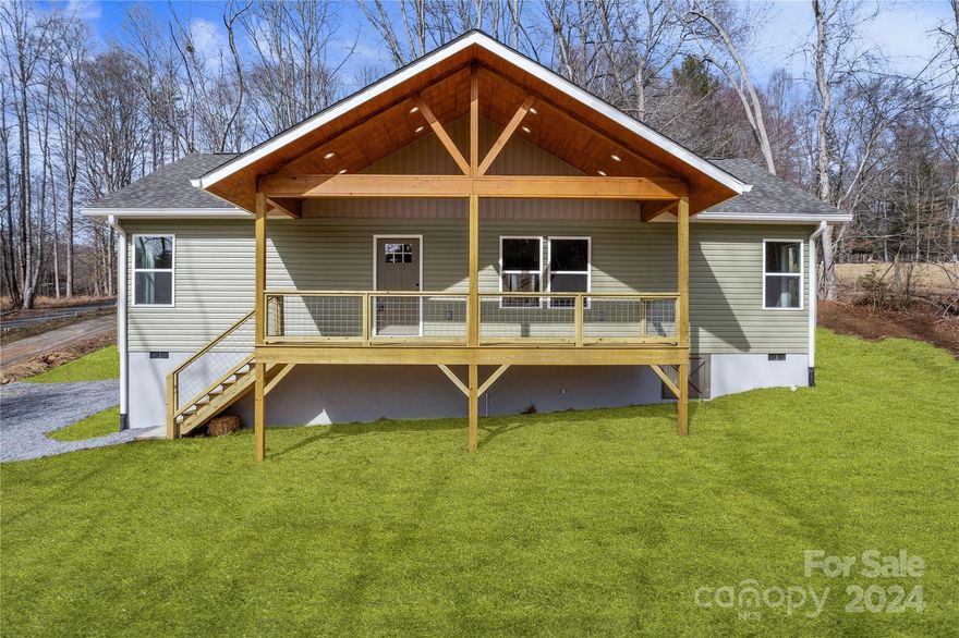 MULTIPLE OFFERS RECEIVED. FINAL & BEST DUE 3/4 BY 2PM. Welcome to your brand-new sanctuary nestled amidst breathtaking natural beauty! This freshly constructed home offers a serene retreat where you can wake up to the gentle glow of the sunrise from your covered front porch. Enjoy mountain vistas & indulge in the tranquility of your surroundings as this property overlooks an enchanting sheep farm nearby. Inside, the open floor plan boasts vaulted ceilings and recessed lighting, accentuating the spaciousness of the living areas. Beautiful wood floors lend warmth & character to the space. The upscale kitchen is a chef's delight w/granite countertops & stainless appliances. Enjoy a split bedroom floor plan, where the primary suite awaits w/a walk-in closet & dual sinks in the bath. Relax & entertain on the expansive back deck. Located on a quiet road with only three other houses, you'll enjoy the peace & serenity of country living while still being just 20 minutes from downtown Asheville.