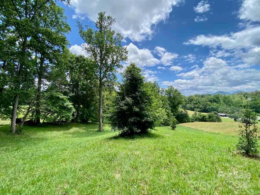 A rare opportunity awaits with this 1.16-acre parcel at the peak of River Crest, one of the most desirable hamlets within Olivette—a nationally recognized agrihood just 15–20 minutes from downtown Asheville. This homesite offers both practical readiness for building and access to an extraordinary community lifestyle.

The land itself is gently rolling and already cleared, providing flexibility for multiple build options. From nearly every angle, you’ll enjoy year-round mountain views and a southern exposure that maximizes natural light and supports energy efficiency and solar potential. Natural buffers create tucked-away private spaces, making it easy to design a home that balances openness with privacy.

Practical features include city water, state-maintained roads, underground utilities, and a septic permit—helping reduce both cost and time in the building process.

Living here means becoming part of Olivette Riverside Community and Farm, a 411-acre community designed around connection to land, food, and neighbors. At its heart is a working organic farm that provides fresh produce and fosters a true farm-to-table lifestyle.

Amenities include:  An expansive riverfront park on the French Broad River, with river access, pavilion, amphitheater, and fire pit;  Miles of trails for hiking and biking; Community gardens, orchards and edible landscaping; A dog park, pickle ball court, playground, and community spaces for gathering.

Olivette has been featured nationally as a model for modern agrihood design, blending mountain beauty, sustainable living, and community connection. This approximately 1.16 acre parcel represents one of the few remaining premier homesites available at Olivette. It is to be subdivided from the parent tract, see survey and deed attached.

If you’ve been seeking a homesite that combines natural beauty, convenience, and a vibrant sense of place, this lot delivers. More than just land, it’s an invitation to join a thriving community that celebrates nature, nurtures connection, and embraces sustainability.

Build your dream home at the peak of River Crest, and experience life at Olivette.