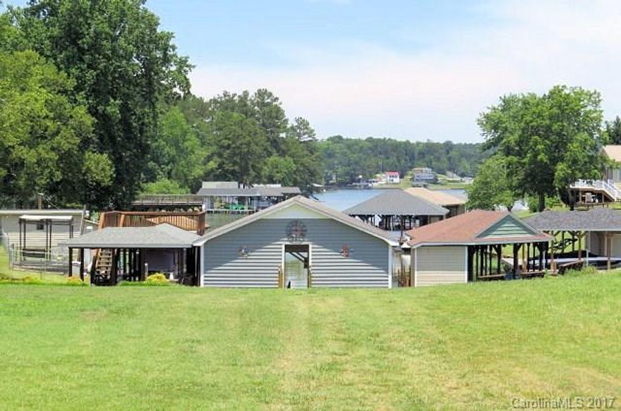 BEST BUY ON Waterfront Lake Tillery lot with newly renovated boathouse with new roof, a storage area and a great place for waterfront entertaining.  This is a huge boathouse and this level lot has city water and sewer available!  You can enjoy the boathouse now and build when you are ready.  The fishing is great on Lake Tillery year round!  This lot is already cleared and just waiting for your lake home!