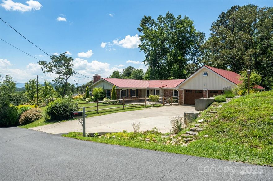 This single-level 3-bed, 3-bath home in Asheville’s desirable Beaverdam area offers 2,249 sq/ft of comfortable living space. Inside, you'll find a spacious living/dining area, family room, and a bright sunroom perfect for plant lovers. The kitchen provides ample storage, seamlessly connecting to the main living areas for effortless entertaining. Two renovated bathrooms feature quality finishes, and the primary suite serves as a peaceful retreat with en-suite bath and office nook. A large attic with permanent stairs offers convenient storage or future potential. The quiet and private .69-acre level lot includes a fenced front yard, mature grass, garden beds, and frequent wildlife sightings including deer, bears, and wild turkeys. The flat driveway leads to an oversized two-car garage with space for a workshop. Brick exterior and a metal roof offer low-maintenance durability. Conveniently located just minutes from Merrimon Avenue and North Asheville amenities.