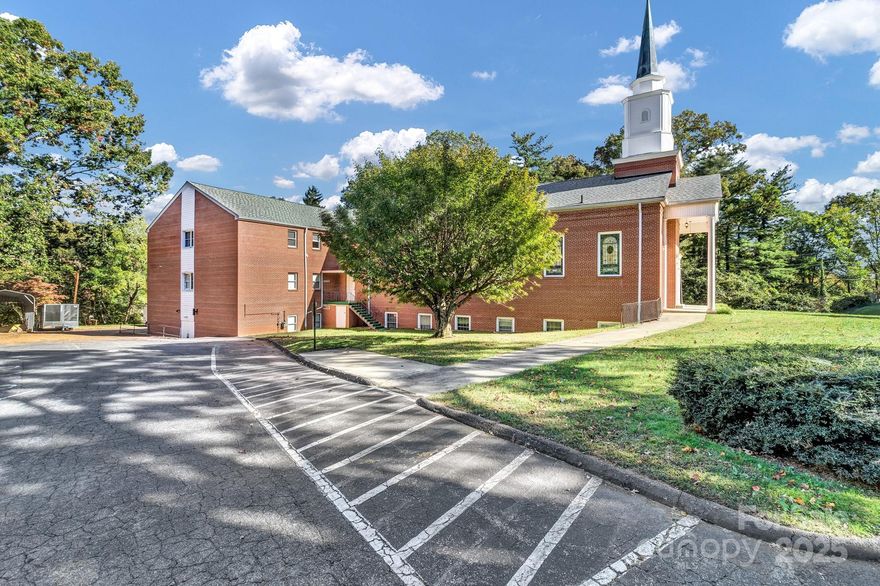 Expansive 14,000+ SF Church Campus in Downtown Asheville – Endless Possibilities for Growth, Ministry, or Redevelopment. This remarkable 14,000+ square foot church campus is a rare find just outside of downtown Asheville. Ideally situated on a quiet neighborhood street yet backing up to commercial property along Tunnel Road, this property combines peace and privacy with exceptional convenience. Mineral Springs runs parallel to Tunnel Road, offering a serene natural backdrop to this highly versatile site. The main church building features an impressive sanctuary designed to accommodate large gatherings, surrounded by functional spaces ready for ministry, community outreach, or adaptive reuse. Inside you’ll find 4 conference rooms, 17 private offices, 3 nursery rooms, 5 bathrooms, 2 full kitchens, 3 laundry areas, 3 mechanical rooms, and 1 half bath — providing ample room for administration, youth programs, education, and hospitality. Sitting on approximately 2.26 acres, the property includes an outdoor playground area and abundant parking, with space remaining for future expansion or additional development. The grounds offer flexibility for growing congregations to add new facilities, for nonprofits or government agencies to establish administrative offices, or for developers to envision a complete redevelopment — whether into condominiums, apartments, or mixed-use space. This location provides easy access to downtown Asheville, Tunnel Road, and major travel corridors, placing it close to shopping, dining, and essential services. The combination of accessibility, size, and layout make this a truly one-of-a-kind opportunity in one of Asheville’s most desirable corridors. Whether you’re a growing church seeking to expand your ministry, a business or organization looking for a functional office or meeting campus, or an investor ready to reimagine the site’s future potential, this property is ready to meet your vision. Additional Opportunity: The church parsonage is also available and listed separately under the residential MLS# 4303297, providing additional living or office accommodations adjacent to the main property. Bring your vision — this exceptional downtown property offers room to grow, space to serve, and potential limited only by your imagination.