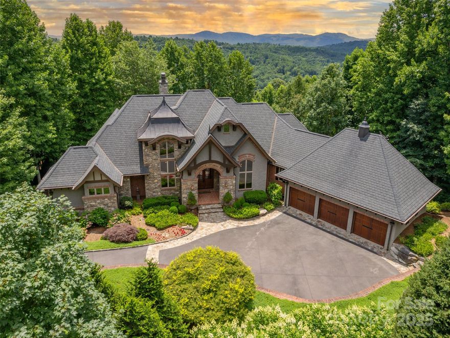 This stunning home is located in prestigious Champion Hills, home to Tom Fazio’s “Mountain Masterpiece” golf course. It’s perfectly nestled to enjoy lovely privacy and unobstructed panoramic southern views. The design is European-inspired and a true masterpiece, with great attention to detail and boasting nearly 3,000 sf on the main level. The chef’s kitchen is a culinary dream with mahogany cabinetry, top of the line appliances and flows seamlessly into a spacious Great Room with limestone fireplace. The romantic primary suite offers a serene retreat with fireplace and luxurious finishes. The lower-level living is equally impressive, featuring a spacious family room with fireplace, kitchenette, wine cellar, and 3 perfectly appointed ensuites. Fabulous outdoor living includes 2 levels of covered porches with fireplaces, one has a built-in kitchen. This exquisite home is truly exceptional; combining a warm and welcoming feel with elegance, functionality and gorgeous views.