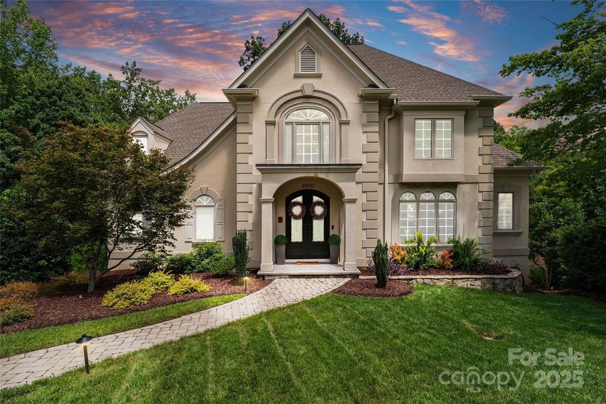 Discover timeless design, privacy, and expansive living in the coveted Giverny community. This custom home spans three finished levels of low-maintenance luxury, just minutes from SouthPark Mall.

Set on an elevated lot with mature landscaping, the home welcomes you with light-filled, open-concept spaces, gleaming hardwood floors, and designer finishes throughout. The chef’s kitchen features high-end appliances, custom cabinetry, and serene views of Giverny Lake, flowing seamlessly to dining areas and an expansive deck—perfect for entertaining or relaxing.

The main-level primary suite offers a cozy fireplace and spa-inspired bath. Upstairs, multiple bedrooms and flexible spaces accommodate family, guests, or hobbies, while the finished lower level provides additional versatility for a media room, gym, or private retreat.

With a rare combination of space, privacy, and premier location, this Giverny estate delivers the perfect balance of luxury and lifestyle—minutes from shopping, dining, top-rated schools, and greenways. Your next chapter begins here.