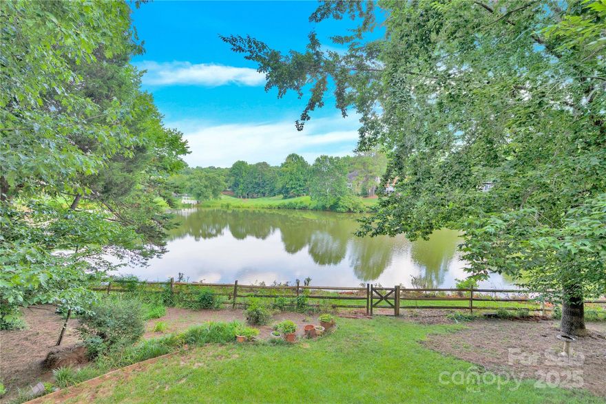 RARE 4BR/2.5BA home in Davis Lake (on the lake) with PRIMARY ON MAIN w/remodeled en-suite bath! Only 2 owners. Freshly painted interior/exterior, hardwoods throughout main level, new carpet upstairs. Spacious kitchen island, breakfast area leading to large deck, Great room w/ cozy fireplace and soaring ceiling, floor to ceiling windows with lake views, flex room/office space, dining room and laundry ALL ON MAIN. Upstairs has 3 spacious bedrooms, full bath, BONUS ROOM, huge walk-in attic, PLUS additional storage off one BR. Enjoy peaceful mornings or sunset evenings from the deck overlooking the lake. Large fenced backyard. Paddle boat, canoe, paddle board, or fish right from your own backyard. NEW ACs & furnaces 2025, Roof 2016, WH 2023. Truly move-in-ready without worry of any of these large expenses! Tons of amenities - pool, clubhouse, tennis, pickleball, volleyball, park. Close to shopping, I-77, I-85, airport, UNCC, UPTOWN CHARLOTTE.  All furniture negotiable except primary BR.