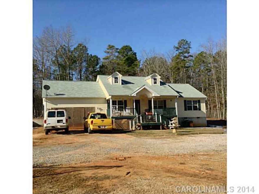 Lovely one level custom built 3BR/2BA. Features: 3/4 pre-finished hardwood flooring, almost an acre fenced, rocking chair front porch, with 22X26 workshop/garage, almost 1500 square feet. Lots of closets and storage. Builder lives in home but has not been able to finish cabinets. Needs TLC to finish cabinets and drawers in the home. Also needs garage door.  Priced based upon current condition.