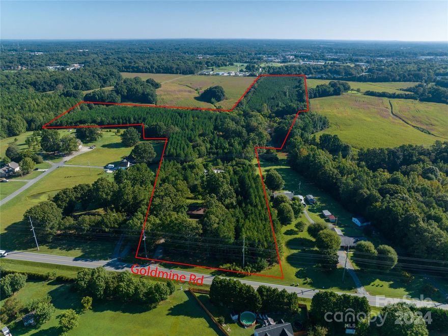 Excellent location with 29+ acres and brick ranch style home in Monroe, Union County NC. Over 300' of road frontage. Private creek. Established, heavily wooded pine tree farm replanted 12 years ago provides haven for deer and other wildlife. Water and sewer available. Can be combined with adjoining MLS# 4207715 (54.52 acres) to total 83.74 acres. Ideal to subdivide and build multiple homes for private use or re-sale subject to zoning and subdivision requirements. Aerial videos available. Property may have existing buried oil tank near house. Current zoning of RMD (Residential Medium Density) allows for 12000 sqft minimum lot sizes with at least 75' of road frontage. Listing agent David Kluth is minority shareholder of seller Goldmine Farms, Inc.