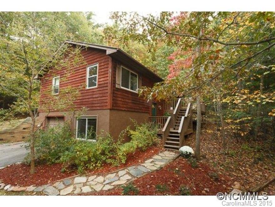 Wonderful home nestled in the trees in convenient East Asheville.  Enjoy this low maintenance, large lot in a private setting with winter views, yet only 10 minutes from downtown Asheville. Outdoor lovers will appreciate location near great trails including mountains to sea trail. 3 bedroom / 2 bath home has numerous updates including granite countertops and a new METAL ROOF, new water heater, new refrigerator, new tile and wood floors.