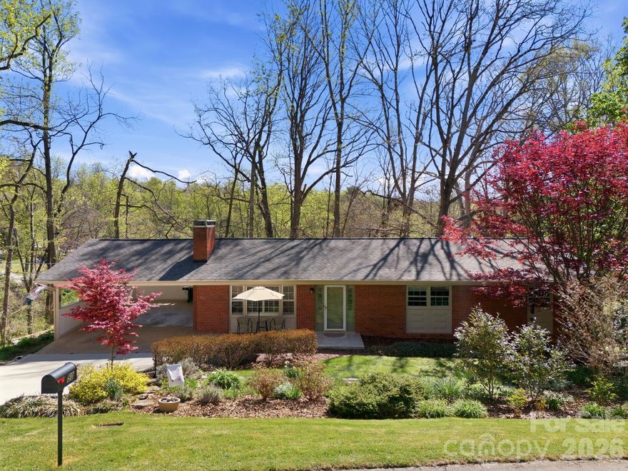 Tucked into a neighborhood with easy access to local shops, dining, and parks. This 3-bedroom, 2-bathroom mid-century rancher blends warmth and character with thoughtful updates throughout. Filled with natural light, the main level showcases beautiful hardwood floors and custom built-ins that surround a gas-log fireplace. The kitchen is both functional and timeless, complete with custom-built solid wood cabinetry with convenient pull-out drawers designed to maximize storage. The bedrooms are generously sized, offering comfortable and versatile spaces. Downstairs, the lower-level living room is a standout—perfect for a cozy TV or movie-watching retreat. You’ll also find a separate workshop and storage area, ideal for hobbies or organization. Step outside to enjoy a peaceful back patio surrounded by nature, with a charming path leading down to a deck—perfect for relaxing or entertaining. A carport adds everyday convenience, rounding out this thoughtfully designed and move-in ready home.