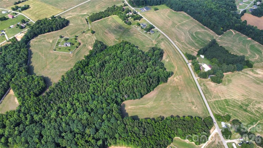 Excellent development opportunity or private residence tract in Mooresville in Rowan County with a total of 49.31 acres.  There is approximately 1400 ft +/- paved road frontage on Deal Road.  There are 2 streams on the property.  A portion of the property is cleared and the other portion is wooded.  (Subdivisions of more than 7 homes will need to contact the Zoning Dept of Rowan County to get approval.)  Per Rowan County Zoning, single family parcels must be at least 40,000 square feet in area for this parcel due to being in watershed II Coddle Creek.  See email from Rowan County Zoning Dept in the property attachments.  Wooded areas feature large Pines and Poplar trees that are over 100 years old, per County Ranger.  Survey and Aerial and Contour Map are attached.  Less than 15 minute drive to either Kannapolis Parkway, downtown China Grove or downtown Mooresville.