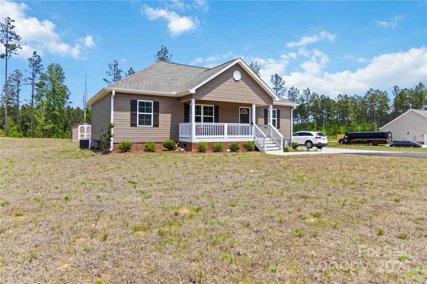 Still New! Open Floor Plan features Large Great Room, Eat In Kitchen and Covered Front & Back Porches.  Kitchen has Granite Counter Tops, Subway Tile Backsplash and White Soft Close Cabinets.  Restoration Arcadia Smoke Laminate Flooring in Kitchen, Great Room and Hallways.  Primary Suite with Trey Ceiling, Walk in Closet and Private Full Bath w/Walk in Shower.  All Electric Home with Well and Septic for Lower Utility Bills.  Only 2 Minutes from I-77, 20 Minutes from Rock Hill and Less than an Hour from Columbia.  Don't Miss your Opportunity to Own a Home in a Community with No HOA or Covenants and Restrictions.