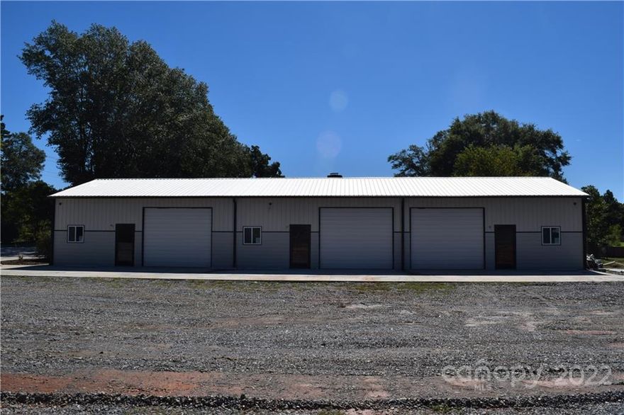 3 acres 2 acres zoned C-3 with new 2700 sq ft building divided into 3 bays approved plan for 12 total buildings pad ready cleared and fenced ideal for mini storage facility outside storage 1 acre zoned  C-1  presently used as office with over-sized double garage extra storage  First class building  100 x 140 approved outside storage  fenced gravel