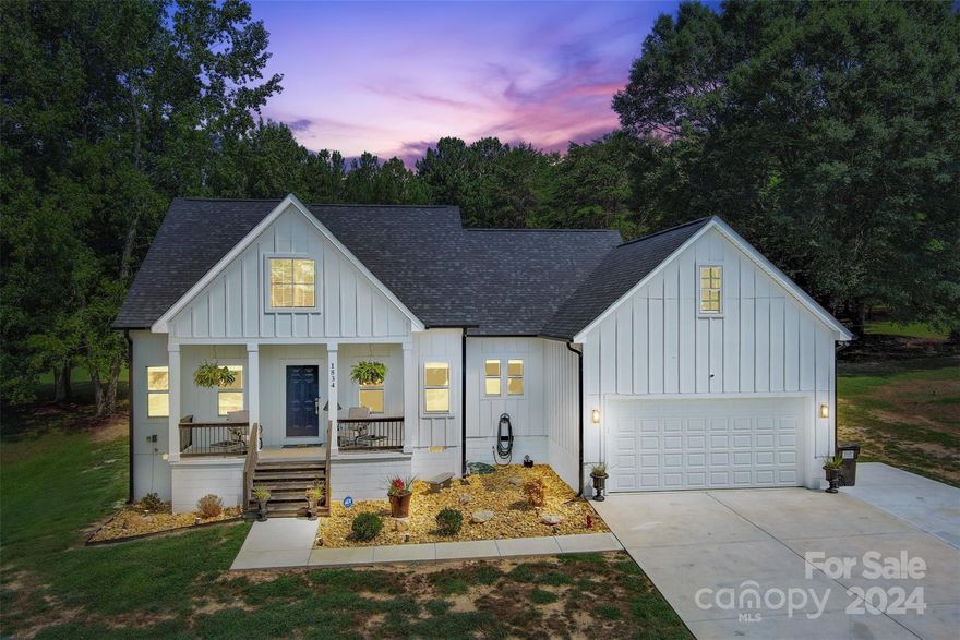 Welcome to 1834 Boy Scout Road, a charming one-level new construction ranch home in Lincolnton, NC. This 3-bedroom, 2-bathroom residence sits on over an acre of picturesque land, offering a peaceful country-like lifestyle just moments from historic downtown Lincolnton. The open floor plan features laminate wood floors and neutral paint throughout, creating a bright and inviting living space. The kitchen boasts granite countertops, a large island, perfect for casual dining and entertaining. Enjoy the outdoors from the comfort of the covered front and back porches. Additional features include a detached storage building for all your storage needs & additional entertaining. Experience the perfect blend of rural tranquility and convenient access to city amenities at this delightful home.