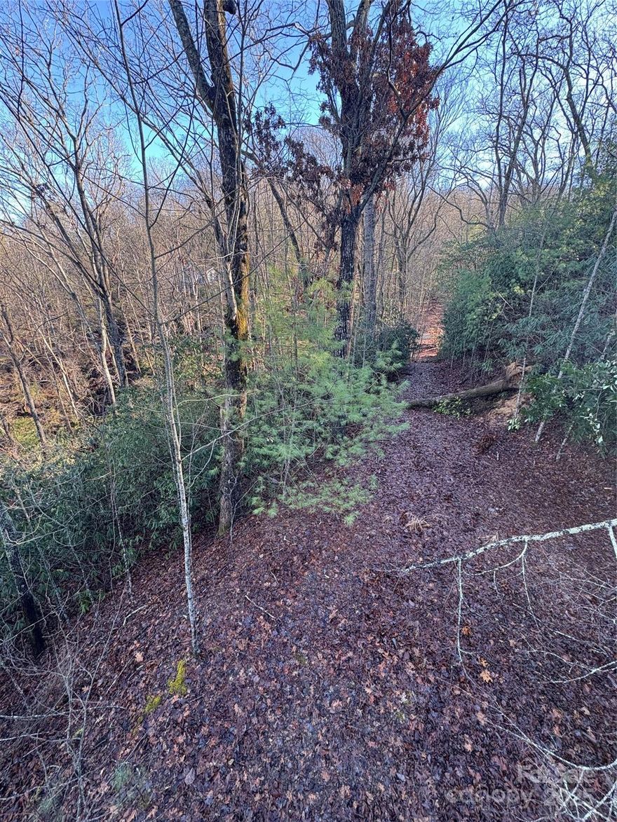 Build your dream home in this lovely neighborhood! This 2.25 acre lot has a roughed in driveway, access to a community well, and mountain views. The peaceful neighborhood has a neighborhood pond, walking trails, and mountain views. It is conveniently located about 15 minutes to downtown Hendersonville, 20 minutes to the Asheville Airport, and less then 20 minutes to both Pisgah forest and Dupont State Park. 
The neighborhood has 2 entrances. The main entrance is off of Patterson Road. The entrance on Willow Creek requires driving across a creek.