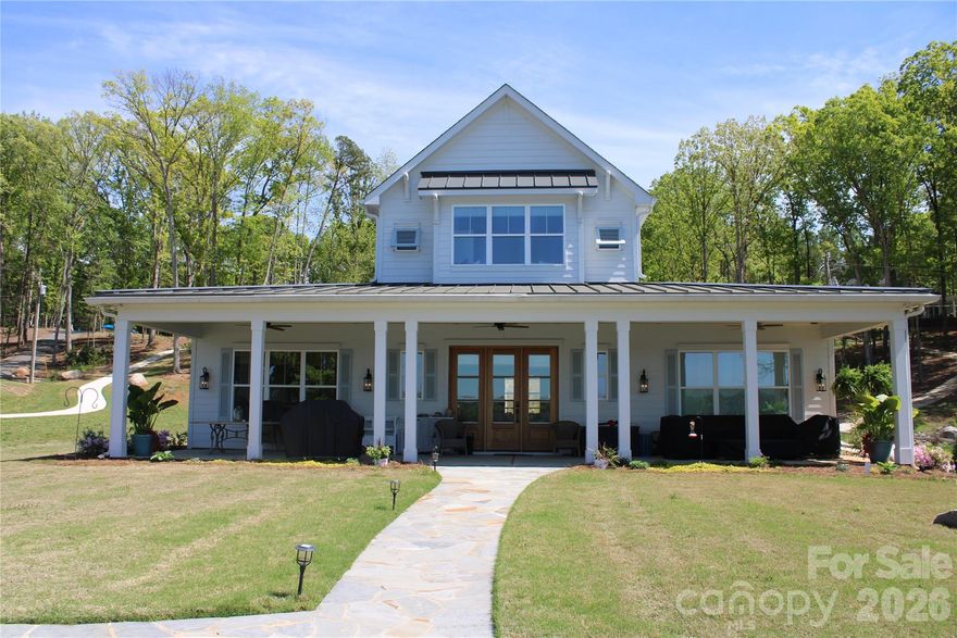 Experience elevated lakefront living on beautiful Lake Wylie in Charlotte, NC. This stunning 4-bedroom, 5-bath home blends comfort, style, and effortless entertaining in a prime location just minutes from shopping, dining ,uptown Charlotte, and airport.

Step inside to an open-concept floorplan filled with natural light, anchored by a spacious family room featuring a custom wet bar complete with beverage fridge and icemaker—perfect for hosting gatherings. The chef’s kitchen is a true centerpiece, highlighted by a large island, ample workspace, propane cooktop and seamless flow into the main living areas.

The owner’s suite is a private retreat, offering generous space and a spa-inspired bath with a soaking tub, walk-in shower, and luxurious finishes designed for relaxation.

Outdoor living is just as impressive. Enjoy peaceful mornings and sunset views from the expansive covered front and back porches. The private covered dock with lift and seating makes lake days effortless, while the large backyard propane firepit area creates the perfect setting for evenings under the stars, entertaining, or simply unwinding by the water.

A detached garage adds versatility with an incredible bunkhouse featuring a flex space/office and bath—ideal for guests, extended family, or a private office retreat.

With room to enjoy both indoors and out, plus direct access to watersports and all that Lake Wylie has to offer, this property is a rare opportunity to own your own slice of waterfront paradise.