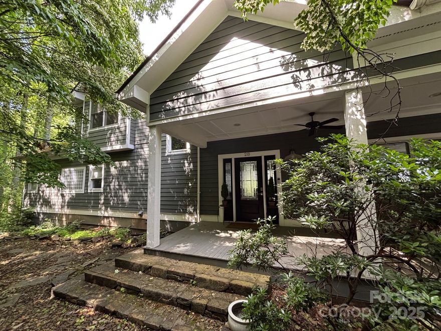 Just minutes from downtown Asheville, this lovely home checks all the boxes:  main level garage with easy first floor entry.  The primary bedroom suite, guest bedroom suite, huge open-concept great room/kitchen/dining area are all on the main floor!  The private primary suite has a large shower and a separate tub.  An oversized laundry room, also on the main floor, has ample storage/multiple laundry appliances.  The upper level boasts another guest bedroom, large bonus room (currently used as a bedroom) with ensuite full bathroom, 2nd bonus room (currently used as a bedroom), and two full bathrooms located nearby.  The large deck is located on the view side of the property and is easily accessible from either the living room or kitchen area; entertaining is a joy with the indoor and outdoor spaces flowing together so easily.  The property consists of two lots:  the home is situated on LOT 1; LOT 2 remains undeveloped for the new owner's imagination.  This home doesn't disappoint!