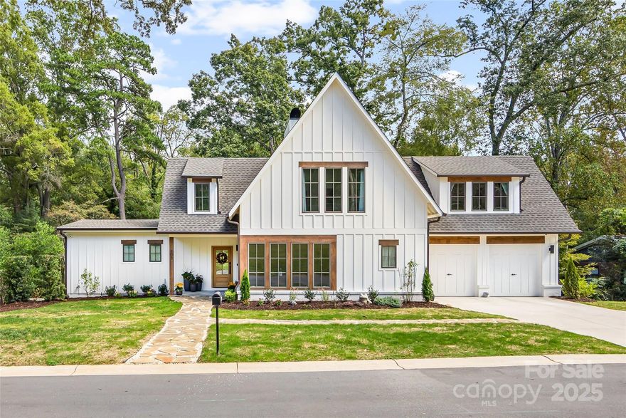 Beautiful, fully renovated mid-century modern basement home one block from restaurants, Summit Coffee, Main Street Books and other shops on Main Street Davidson. The property is .44 acres and is a 5 minute walk to the Davidson College campus. The comfortable home is filled with light from the large windows and has wonderful views of the beautiful woods behind the property. The house renovation was designed by local architect, Nicole Perri, and underwent a complete remodel including significant additions. Despite the extensive changes, the original structure of the home was preserved. Beyond the original foundation and studs, every other aspect of the home is brand new. This includes a complete overhaul of the electrical system, with new wiring throughout and installation of underground power lines. All plumbing has been replaced, including plumbing pipes leading out to the street, ensuring modern reliability. The renovation process was highly hands-on, with the owners involved in every decision. From selecting windows and flooring to choosing doorknobs, their meticulous attention to detail is evident throughout the home. The owners even took special care to preserve the wood from a beautiful large red oak that had to be removed from the property and utilized it as hardwood floors and stairs in the home. The result is an absolutely fantastic residence, where every feature has been thoughtfully considered and executed. The home has 5 bedrooms, each with its own bath. The primary bedroom with en suite bathroom is on the main level along with a large great room that is open to a spacious kitchen and dining room, scullery, laundry room, drop zone, office/den and large partially covered deck. Upstairs there is a loft, two more large bedrooms and two en-suite bathrooms. The basement offers an entire separate living space with two bedrooms, two en-suite bathrooms, large family room with wet bar, kitchenette and dining/den area. There is ample storage in the basement with over 460 square feet of partially finished/heated space and another 107 square feet of unfinished space. Walk out of the basement to a large covered patio and two additional patio spaces. Yard has been landscaped and new lawn seeded after completion of all construction. Two-car attached garage with wiring for electric vehicle chargers. Additional concrete parking area to the right of driveway.