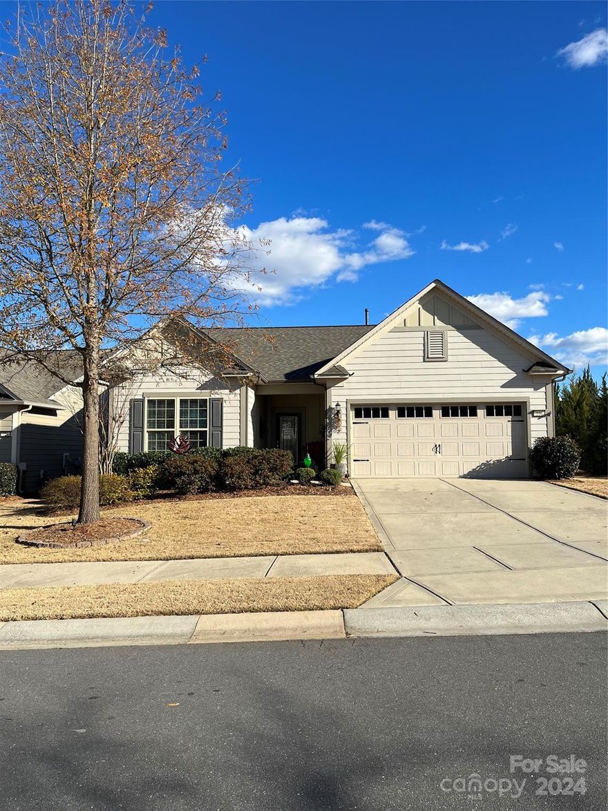 Popular Abbeyville model with 2 BR, 2 Bath, Office with French doors and open floor plan sits on a premium, private end lot. This well-appointed home features many upgrades including a custom walk-in master closet, frameless glass shower door and special finish on shower floor in master bath, tiled shower in guest bath, newer LVP flooring throughout main living areas, KitchenAid SS appliances, granite w/stone back splash and a beautiful decorative glass front door. The spacious laundry room has cabinets and features a large storage area!  Textured coatings added to the concrete slab at the front door and under the covered lanai in back make them aesthetically appealing.  Whether it’s the morning sun or the late afternoon shade, you won’t want to miss the beautifully landscaped large stone patio—perfect for backyard entertainment. The fireplace, blinds, energy efficient radiant barrier sheathing, garage door keypad and outside up-lighting in the front yard also compliment this home.