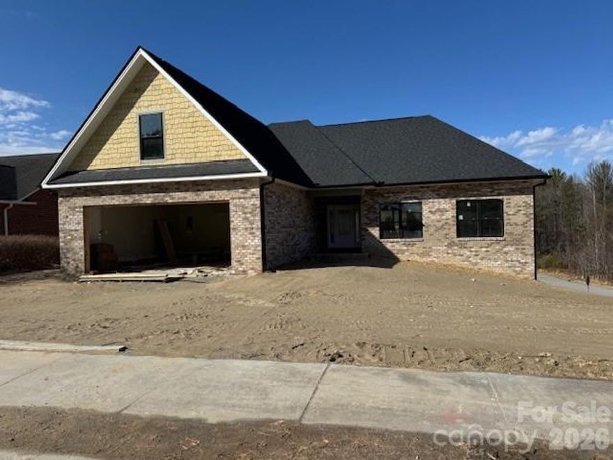 This stunning ALL-BRICK NEW CONSTRUCTION offers timeless craftmanship with panoramic year-round mountain & city views designed to be enjoyed in every season!  Thoughtfully positioned windows and an open living spaces frame the scenery while filling the home with natural light! A stylish single level 3BA/2.5BA with bonus room and a FULL UNFINISHED BASEMENT, framed and ready to finish! Located in Lenoir, THE GATEWAY TO THE NC MOUNTAINS! The welcoming foyer sets the stage to this gorgeous new home! Detail and quality are displayed throughout. From the wide plank floors to the custom kitchen with shaker-style cabinetry that offers a timeless, clean-lined look.  A spacious center island anchors the room, providing both additional prep space and a natural gathering spot for everyday living and entertaining.  Carefully planned and both stylish and functional, the spacious living room has access to the covered back deck which expands to an uncovered deck.  The split bedroom layout provides privacy for the owner. The primary suite offers a large WIC & private ensuite bathroom with tiled shower. Large pantry & laundry room with custom cabinets. 2 car garage! Conveniently located to restaurants, medical, etc.! Easy drive to Blowing Rock or Hickory!