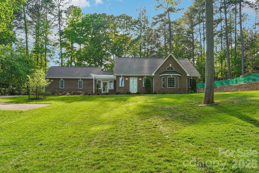 RARE OPPORTUNITY on Stonemarker Road—a private Lake Norman retreat offering immediate serenity and future potential. This cozy 2BR brick ranch sits 200ft back on a 1-acre lot with seasonal lake views and a deeded boat slip. Perfectly appointed for downsizing or a lakeside start, the home features a vaulted great room, gas fireplace, and upgraded systems including a 1.5HP constant pressure well. With a permitted septic design through 2028, it is ready for your custom addition!
________________________________________
Key Things to Know
• Prime Seclusion: Situated 200 feet back from highly desired Stonemarker Road
• Lake Access: Includes a deeded boat slip and a dedicated 30-foot on-site pad for boat or RV storage.
• Upgraded 1.5 HP constant pressure well system, 12-zone irrigation, and whole-house water softener.
• Future Growth: County-permitted septic upgrade design in hand and valid through 2028