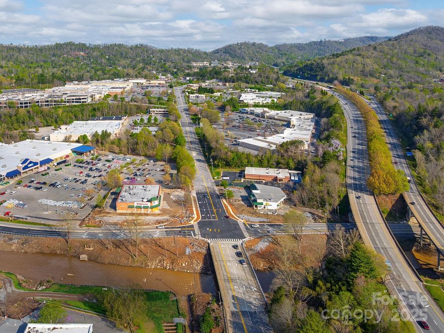 Signalized corner location This location is across the street from Lowe’s and Walgreen’s and right in the center of a retail trade area with Global retailers like Walmart, Target, Dick’s and Ross. Excellent visibility and access from Swannanoa River Road and S. Tunnel Rd. This is the largest retail trade area west of Charlotte! The property was damaged from hurricane Helene, the existing building shell of the former strip center of approximately 8989 SF can be used and is structurally sound (owner has report). Price TBD.