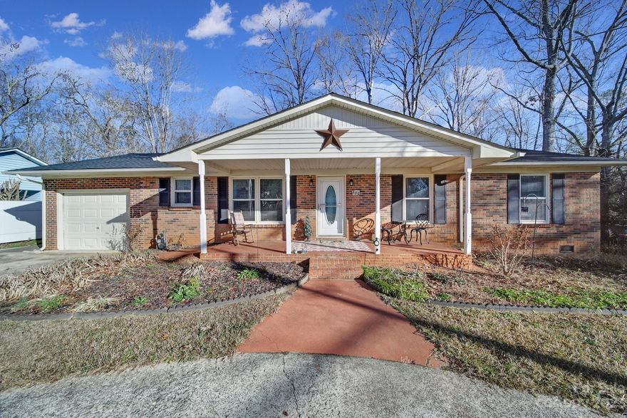 Pull into the convenient, circular driveway for a grand introduction to this unique ranch home just a half mile from the USC Lancaster campus. When you enter, you'll instantly notice it's unique character. The living room w/ built-ins is open to a 2nd living area sitting in front of a large brick wall w/ a fireplace. The dining area is off to the side opening up to the modern kitchen which was completely updated in 2023 w/ white quartz countertops, SS appliances, cabinets, tile floor, & backsplash. You'll find 3 bedrooms & 2 full bathrooms down the hallway including the primary suite. The enclosed sunroom (once a porch) is heated/cooled for a perfect spot to overlook the wooded backyard on a rainy day. The attached one car garage is perfect for a car, storage, workshop, or to use as a flex space. Also in 2023, the deck was replaced with a large Trex deck. New HVAC in 2021. A major bonus coming w/ this property is the oversized workshop in the backyard.