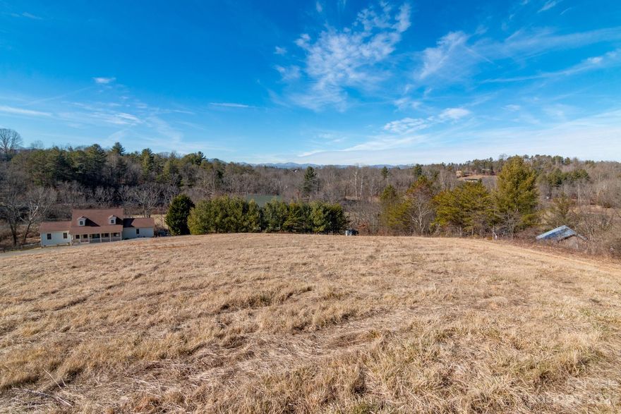 This is the last remaining lot on Apple Meadow Ln, a street with just 4 other parcels and well kept site built homes. Offering tremendous privacy, the property is surrounded on three sides by mature trees and has a build site perched above the other homes on the street. The land slopes gently upward off the road through a cleared pasture to a site where there is potential for short range and long range mountain views. The sellers have already perk tested the soil and have a report authorizing a four bedroom engineered septic permit. Current list price has already been reduced to off set the cost of septic for future buyer. When you are on the property you will feel removed from the bustle of Asheville while still having the draw of downtown just 15 minutes away. This property offers little risk and great reward for the next buyer looking to build a new home in the mountains of North Carolina.