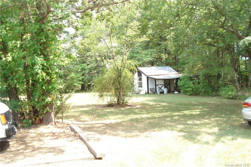 Acreage AND a great location! Almost 3 acres in a prime location near Mooresville and Davidson yet still in Cabarrus County. The property is level/sloping; cleared at the front and heavily wooded in the rear. No value is given to the older home on the property; however there could be an old well and septic tank on the property. Also the several outbuildings are in fair condition.