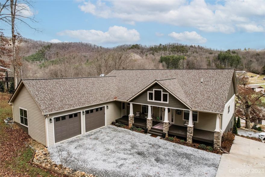 Indulge in refined living at this 2017-built, 4-bed, 4-bath Franklin home. The owners have meticulously enhanced both indoor and outdoor spaces, featuring a charming rocking chair entry porch and a spacious deck with breathtaking mountain views. The main level is designed for convenience, housing all 4 bedrooms and a laundry room. The primary suite is a luxurious retreat with dual vanities, a large walk-in tile shower, and a jetted tub. Luxury defines the living space with granite countertops, stainless steel appliances, and wood and tile flooring throughout. The gourmet kitchen, equipped with a gas stove, opens to a formal dining room. The lower level offers a recreational/family room, bonus/craft room, and a full bath. A barn door adds rustic charm and an unfinished area provides the potential for storage or expansion. A carefully curated water feature enhances the landscaping, creating a tranquil atmosphere. An oversized two-car garage ensures comfort in any weather.
