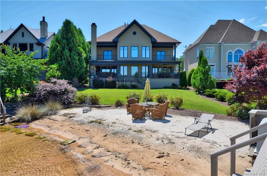 Spectacular waterfront home w/panoramic views from every room. Stunning open floor plan w/gleaming hardwoods.  Beautiful gourmet kitchen includes top of the line SS appliances, tile back splash & granite counters. Luxurious master bath w/dual vanities, whirlpool tub & seamless glass shower. The balcony overlooking the water w/a wood burning fireplace is the perfect place to take in the lake views. Relax in your backyard oasis w/ a sandy beach, floating dock & deeded boat slip.