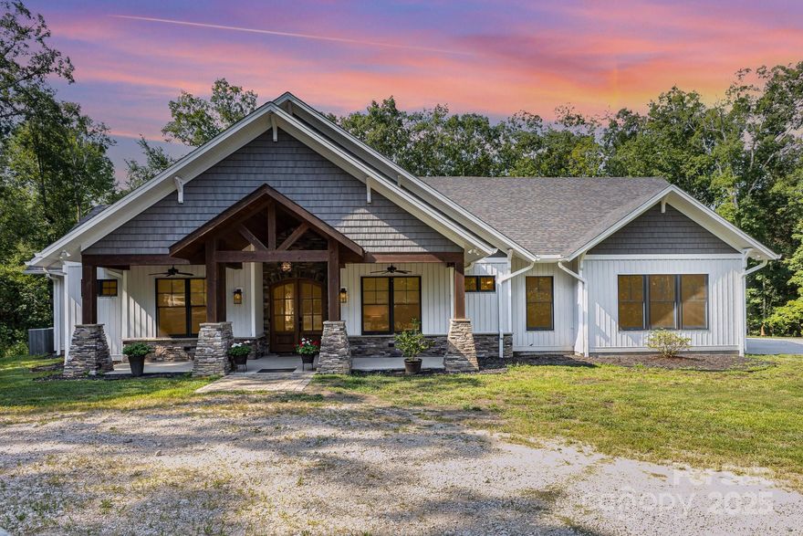 Dreaming of lodge-like comfort and resort-style amenities with space designed for exactly how you want to live? Welcome to your private retreat. This thoughtfully crafted home radiates warmth and tranquility, blending spa-inspired finishes with seamless modern functionality. Set on 44 wooded acres just minutes from I-85, it’s your escape into nature—without compromising convenience.This warm, spa-like home features 3 beds, 3 full baths, and a luxurious primary suite w/ walk-in shower, soaking tub, and leathered granite double vanity. Chef’s kitchen w/ huge island, leathered granite, double oven, and surround sound opens to den w/ stone fireplace & sunroom. Saltwater fiberglass pool w/ metal fencing + outdoor AV wiring. 972 sq ft attached garage w/ 3 industrial doors, tall ceilings, & reinforced concrete. Septic permitted for 4 beds. A private resort-style haven with every detail in place!