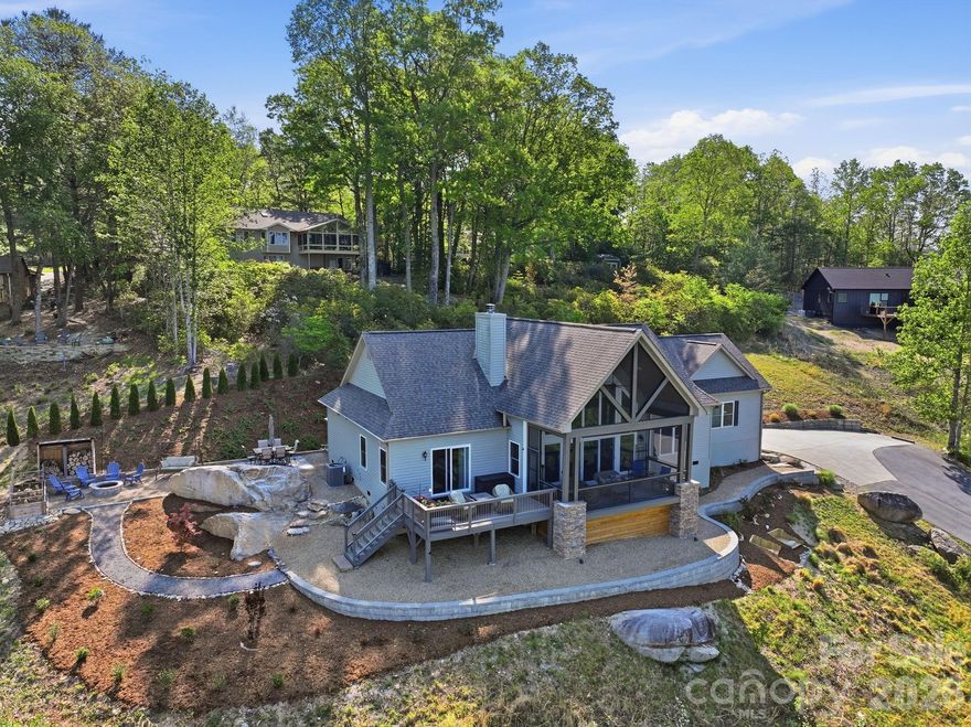 467 Crystal Heights Drive is a thoughtfully designed three-bedroom, two-bath home built in 2019, set high within the Crystal Heights community with a clear emphasis on privacy, positioning, and long-range views.

The setting is a defining feature. From this elevated vantage point, the home looks out over the Etowah Valley toward the ridgelines of Pisgah National Forest, with approximately 180-degree, 40–50 mile mountain views. The home is oriented to take full advantage of this perspective—captured from the main living areas, the primary suite, and multiple outdoor spaces including a screened porch, an open sun deck, and a patio with fire pit.

Despite the privacy, the location remains highly convenient. Etowah is just minutes away, offering everyday essentials—grocery, dining, medical offices, and services—while Downtown Hendersonville is approximately 15 minutes, Brevard about 20 minutes, and Asheville Regional Airport also within a 20-minute drive.

Inside, the home is open and functional with a focus on light and scale. Vaulted ceilings and large west-facing windows bring in natural light and frame the view, with remote-controlled window treatments already in place. The kitchen is spacious and well-appointed, featuring a large island, gas range, stainless appliances, granite countertops, and a walk-in pantry that includes additional workspace, a beverage refrigerator, and flexibility for use as a coffee bar or small office.

The primary suite is positioned to take in the view from the moment you wake, with a bathroom that includes heated radiant floors, an air bath tub with EverClean system, and a bidet seat. Throughout the home, solid 5-inch hickory flooring adds warmth and durability.

Additional features include a wood-burning fireplace with a gas starter, a hot water recirculation system for near-instant hot water, a whole-house water filtration system, and a 22 kW Generac generator. The home is served by city water, septic, underground power, high-speed fiber internet, and a buried propane tank.

The garage offers 13-foot ceilings with built-in storage, providing flexibility for equipment, organization, or hobby space.

An adjoining lot is also available for purchase, offering additional flexibility for the property. It could serve as a privacy buffer or provide the opportunity for a second mountain home with similar long-range views.

Within the community, residents have access to a private ~2.5-acre pond suitable for fishing, kayaking, or walking the surrounding trails. Wildlife is a regular part of the landscape, with deer, turkey, and other native species often seen throughout the area.

Come experience this unique setting and perspective for yourself. Call, text, or email the listing agent today for more information or to schedule a private tour.