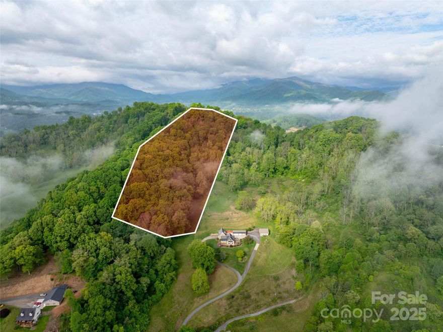 Discover your dream retreat property with this stunning 10-acre parcel in the highly sought-after Jones Cove community of Clyde, North Carolina, just five minutes from I-40 and 23/74, offering easy access to the majestic Blue Ridge Mountains. This pristine property boasts approximately one acre of level, cleared land, perfect for building your ideal home, with breathtaking, long-range mountain views that captivate year-round. Surrounded by lush forests, the land ensures total privacy, creating a serene sanctuary where you can unwind amidst nature’s splendor. With no restrictions, the possibilities are endless—design a modern cabin, a sprawling estate, or a cozy getaway.