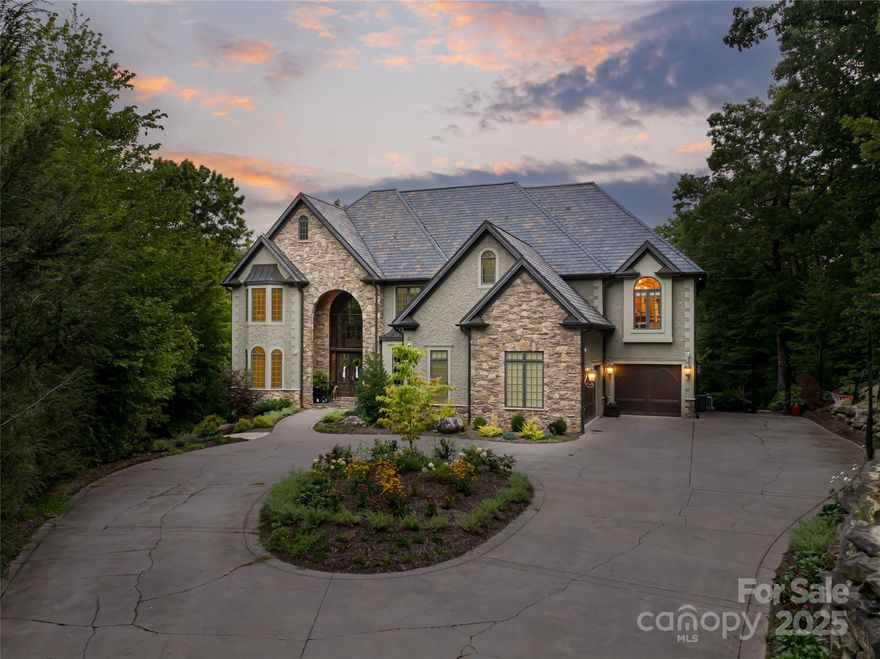 Behind the gates of prestigious Poplar Ridge, this refined residence is a statement of timeless grandeur and modern luxury. Exceptional craftsmanship is evident throughout, from soaring tray and coffered ceilings to arched doorways and rich Brazilian cherry floors. The open main-level design encourages effortless flow, centered around a gourmet kitchen with custom cabinetry, walk-in pantry and premium appliances. A sunlit breakfast nook and elegant formal dining room create inviting spaces for everyday living and special gatherings. Upstairs, the primary suite is a retreat, anchored by a fireplace and complemented by a spacious, spa-inspired bath designed for indulgence. Additional bedrooms and flexible living areas offer comfort and versatility for guests, work or recreation. Outdoors, the estate transforms into a private resort with a sparkling pool, expansive terraces, fire pit and hot tub, all surrounded by lush landscaping and mountain air. Within one of Asheville’s desirable gated communities, this Poplar Ridge home offers an elevated lifestyle defined by elegance, comfort and distinction.