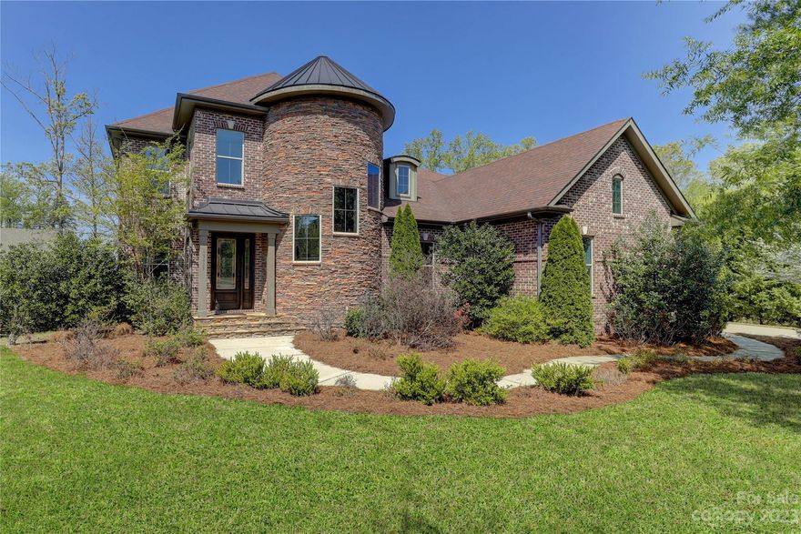 An impressive custom home will delight you when you enter the foyer. The wood & marble inlaid floor & spiral stair w/stone accent wall is a dramatic entry focal point. Formal dining w/ coffered ceiling & butlers pantry w/built-in wine frig. flow seamlessly through arched entryways to the great room. A two-sided fireplace joins the dining and great rooms. The large curved kitchen island, double wall oven, and gas cooktop are perfect for entertaining. A large walk-in pantry. The sitting room just off the breakfast area with built-in wine cabinetry opens onto the main deck with wooded views. Luxury primary suite /double tray ceiling & spa-like bath, oversized dual closets, and private washer and dryer. Upstairs is a large bonus room w/built-in desk that adds tons of flexible space, three beds -shared bath and hall bath, and a second laundry room completes the upstairs. Surround sound system throughout. 3 car garage w/ Epoxy coated floor, built-in cabinetry & beverage frig. Full irrigation