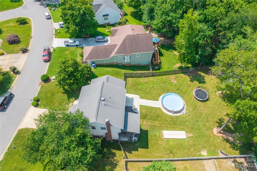 Huge Price Reduction to this Basement Home in Mooresville! This price is now below recent appraised value. New carpet has been added on upper level. Please come discover a 5-bedroom residence boasting an expansive back yard. Step inside to see the formal living and dining rooms, seamlessly connected to the kitchen and great room on the main level. Indulge in the tranquility of the screened-in porch, overlooking the yard, providing a serene space for relaxation. Ascend upstairs to find four bedrooms, including the primary suite with an attached ensuite bathroom. The secondary bedrooms share a second full bath. Descend to the basement to discover a 5th bedroom, alongside a comfortable living room and an office area, offering versatility and additional space. The basement conveniently grants access to a delightful patio and the expansive back yard, making it ideal for outdoor gatherings and recreational activities. This property embodies the perfect harmony of indoor and outdoor living.