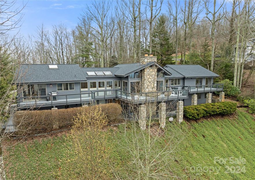 Perched 1000 feet above Asheville amidst the serene Blue Ridge Mountains, this contemporary architectural masterpiece embodies a fusion of luxury and livability. Distinguished by its expansive layout, capacious rooms, and panoramic windows, the residence stands out for its exceptional design. At the heart of the dwelling lies a culinary marvel crafted by Forest Millwork - a kitchen spanning over 500 square feet, serving as a sanctuary for both seasoned chefs and casual cooks alike. A sprawling deck is your personal retreat, offering a sanctuary for relaxation and entertainment. From morning brews to evening wine, every moment finds its perfect setting here. Whether you crave tranquility amidst the peaks or delight in hosting lively soirées, this home, with its awe-inspiring vistas, secluded locale, and luxurious amenities, provides an ideal backdrop for crafting a life defined by comfort, convenience, and the untamed beauty of the great outdoors. Owner is licensed NC broker.