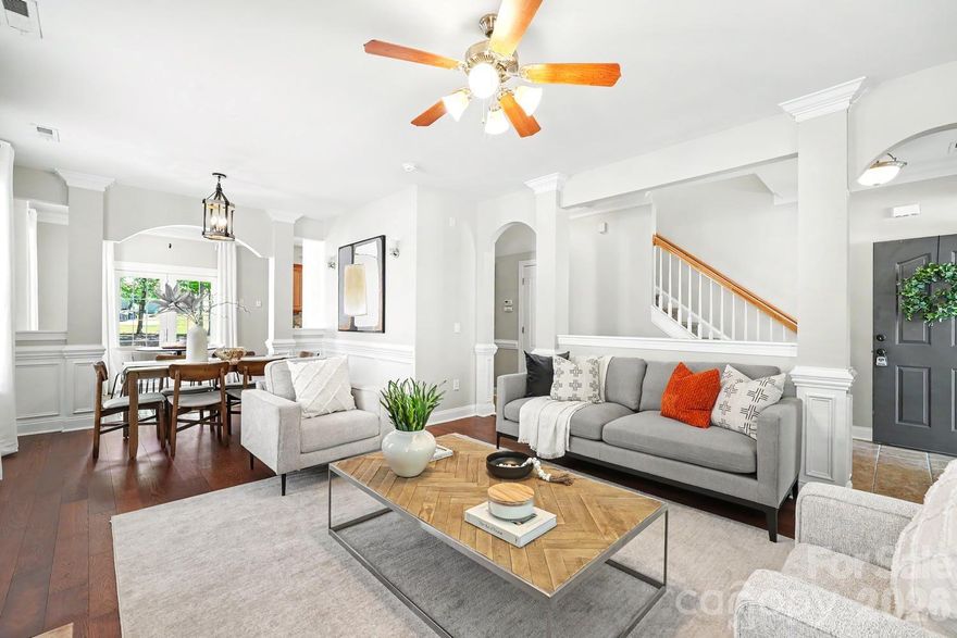 Welcome home to timeless charm and effortless style in the sought-after Crosswinds community. This beautifully appointed 3-bedroom, 2.5-bath single-family home impresses from the moment you step inside with beautiful new floors in living/dining/eat in kitchen, foyer and hall), crisp wainscoting, and elegant arched doorways that lend a classic architectural character throughout the main level. The open floorplan seamlessly connects the living room, dining area, and eat-in kitchen — perfect for both everyday living and entertaining. The living room features a cozy fireplace and ceiling fan, while the formal dining space is highlighted by a striking lantern pendant light and an abundance of natural light. Decorative columns frame the spaces with sophistication without sacrificing the open, airy feel. Upstairs, retreat to the spacious primary suite where a dramatic trey ceiling with crown molding and a ceiling fan create a true sanctuary. Two additional bedrooms and a full bath complete the upper level, offering plenty of space for family, guests, or a home office. This home is truly move-in ready.  Close to multiple  restaurants, 3 grocery stores, and easy fast access short drive to I-77 and 485. Schedule your showing today — opportunities like this in Crosswinds don't last long!