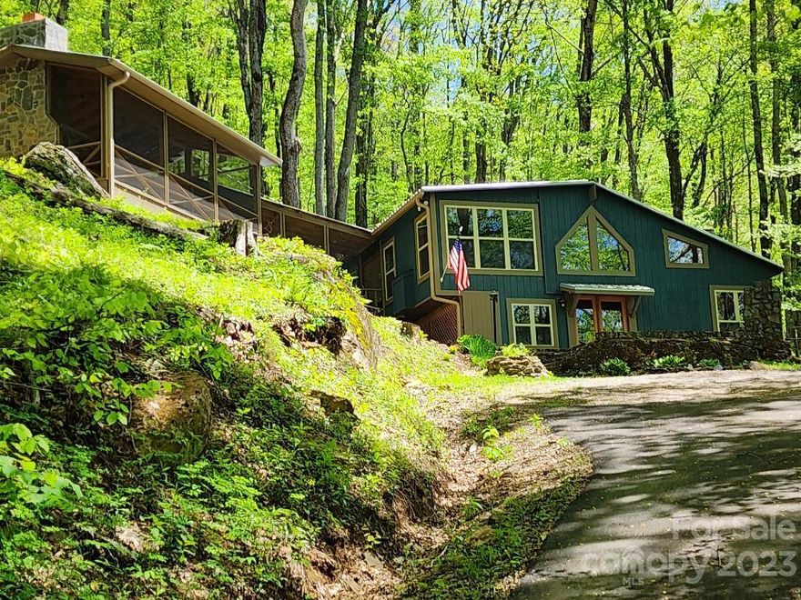 This one-of-a-kind home is the perfect mountain vacation getaway. It's located high in the mountains at almost 4000 ft above sea level. You can escape the heat of summer and enjoy undisturbed peace and quiet. The only sounds you'll hear are the birds and the roar of nearby Cattail Creek. This property features 3 large fireplaces. The 2 fireplaces in the house have gas fire logs. The third fireplace burns wood and is located in one of the most impressive screened patios you will ever see. Even the wide steps leading from the upper level of the house to the 15' x 25' patio are screened. You won't need to bring anything to this house but your clothes and personal items. It is being sold furnished. The house has unique features including a brick accent wall in the kitchen and an old barn wood wall concealing a full bath and bedroom/storage area. This home is located in the very popular Cattail Creek community and is only 11 miles from Burnsville. Come get away from it all in Yancey County.