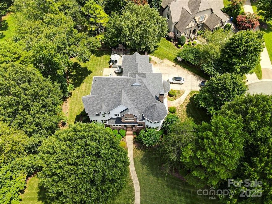 In the prestigious waterfront community of The Point, this remarkable 5-bed, 4.5-bath home offers Lake Norman living at its finest—without the waterfront price tag. Just steps from your deeded boat slip, the home is designed for comfort, elegance, and entertaining. Soaring ceilings and walls of windows fill the space with natural light, highlighting hardwood floors and refined finishes. The gourmet kitchen flows into spacious living areas, while the main-level primary suite features dual walk-in closets and spa-inspired bath. Upstairs, two oversized bonus rooms offer endless possibilities. Outdoors, relax in the recessed hot tub on the rear deck or gather around the stone fireplace on the patio, surrounded by lush landscaping. Enjoy access to the Trump International Golf Club, tennis, pool, dining, and lakefront recreation in on of Lake Norman’s most sought-after neighborhoods. Opportunities to enjoy The Point’s lifestyle at this value are rare—schedule your private showing today!
