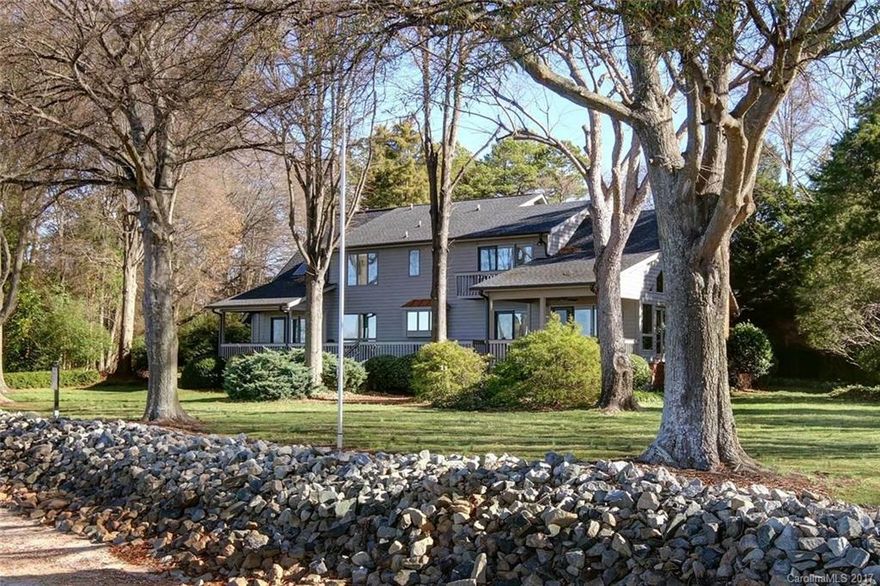 This is a rare find and a rare offering and is fantastically uncommon in every favorable way! Enjoy 1.25 acres, 420 feet of exquisite shoreline and sunset views for as far as the eye can see from all angles of the property. There are plenty of private, rustic, wooded spaces as well as big open spaces. A 65-foot deck spans the entire length of this 3,500-square-foot gem, with both ends offering covered porches. Enjoy your private sandy beach next to your pier and boat lift.