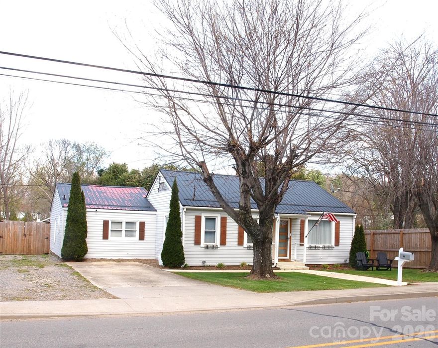 INVESTOR ALERT!  BRING OFFER!  Nestled in the heart of Waynesville’s charming, walkable, Hazelwood area, this partially remodeled 1,342-square-foot home offers the perfect blend of small-town nostalgia and modern convenience. You are just a short stroll away from local favorites like Smoky Mountain Roasters, quaint boutiques, and popular neighborhood restaurants. Designed for a low-maintenance lifestyle, the exterior features a durable metal roof and vinyl siding, allowing you more time to enjoy the vibrant community right outside your front door.
The interior has been transformed with high-end finishes, including a sleek new kitchen outfitted with granite countertops and stainless steel appliances. Comfort and peace of mind are guaranteed thanks to a total electrical upgrade and a brand-new LG mini-split HVAC system. The layout includes two updated bedrooms, highlighted by a primary suite with its own private ensuite bath and walk in closet. Outside, the nearly quarter-acre backyard is a private oasis, fully enclosed by an 8-foot wooden privacy fence. With a 10-foot gate providing easy RV parking, and a pavilion, wired with 110V outlet and television,  ready for outdoor entertaining, this property is as functional as it is inviting.