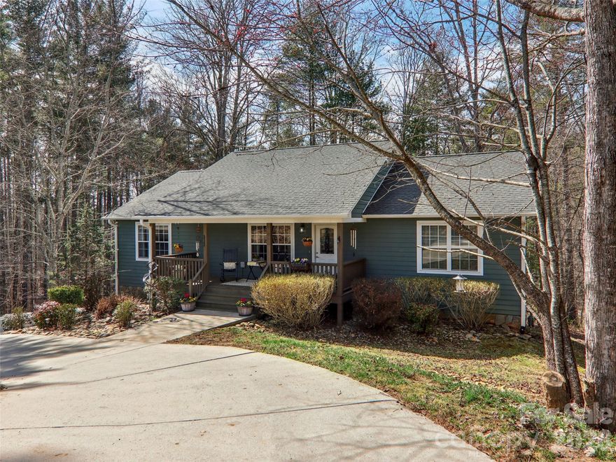 Set in an established neighborhood one mile from downtown Mars Hill, NC, a mountain town just 25 minutes north of Asheville, this 5 bedroom, 3 bath home offers room to grow and gather. The open-concept kitchen with custom cabinetry and a large island flows into the living and dining areas, centered around a cozy fireplace for relaxed evenings at home. The main level features a primary suite plus two additional bedrooms. The finished basement provides a second living area with its own fireplace, 2 bedrooms, 2 baths, heated and cooled storage, attached garage, and private entrance—perfect for guests, hobbies, or flexible living. Enjoy a screened porch overlooking the wooded, low-maintenance lot.