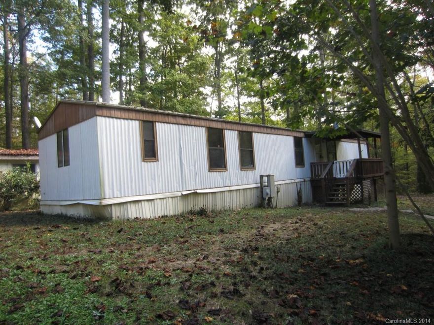 Secluded 2 bedroom, 1 bath single wide with storage building. Home features split floor plan, master suite with separate shower and garden tub, living room with fireplace, cover deck and 2 car carport. Home is in secluded country setting.
