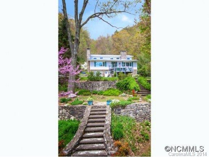 From Main St to Mtn Retreat in minutes! This refuge is home base for a private creekside cove in the mtns. It offers main lvl living with 3 stone fps +2 bed/bath suites up. Gr Rm invites cozy fireside dining & casual living. Also some finished space below + workshop & garage. Easy access, natural waterfall landscaped  w/rhodos,laurel,trillium & hdwds, hiking trails, decks & patios. 3500+ elevation round out the experience. Near Cataloochee.